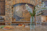 Experience luxury in this gourmet kitchen, featuring a stunning mosaic backsplash and a professional-grade espresso machine.