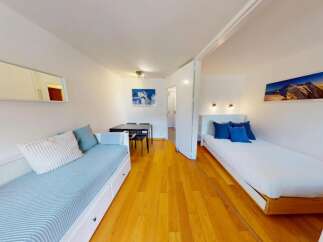 Discover this charming studio apartment featuring a comfortable daybed and a separate twin bed, perfect for accommodating guests.