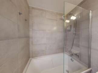 Experience a spa-like retreat in this modern bathroom, featuring a deep soaking tub perfect for unwinding.