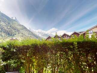 Experience breathtaking mountain views from this stunning property, nestled amidst lush greenery.