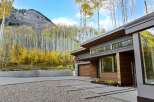 Experience modern luxury nestled amidst the vibrant autumn foliage and majestic mountain backdrop.