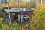 Experience luxury mountain living in this stunning modern home, nestled amidst vibrant autumn foliage.