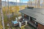 Experience luxury mountain living in this stunning modern home, featuring a private hot tub on the deck with breathtaking forest and mountain views.