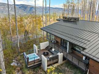 Experience luxury mountain living in this stunning modern home, featuring a private hot tub on the deck with breathtaking forest and mountain views.