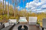 Experience ultimate relaxation on this stunning deck, featuring a luxurious hot tub and a modern fire pit, perfect for enjoying the crisp mountain air.