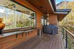 Enjoy outdoor living with this spacious deck featuring a built-in bar and a Weber grill, perfect for entertaining.
