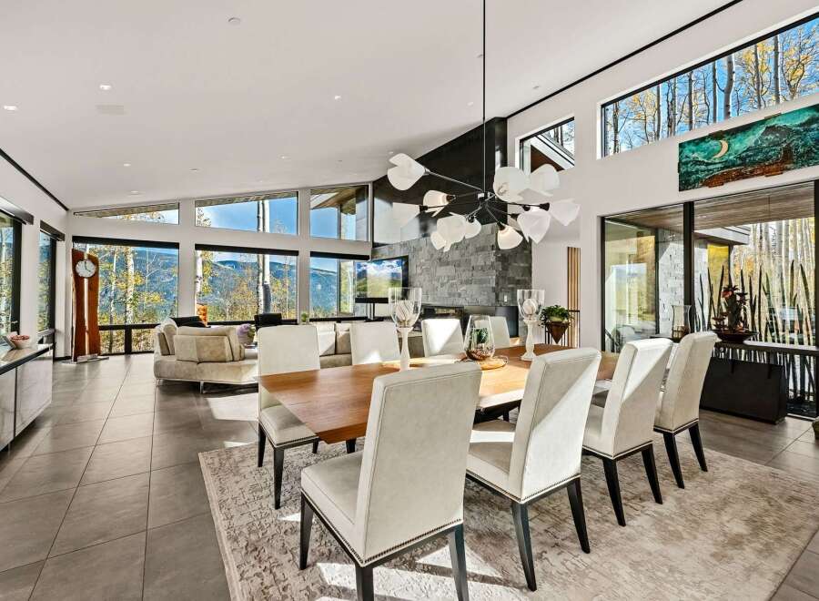 Experience luxury mountain living in this stunning contemporary home, featuring expansive windows that frame breathtaking panoramic views of the surrounding landscape.