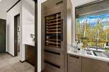 Experience luxury living with this stunning wine cellar, seamlessly integrated into a modern kitchen space.