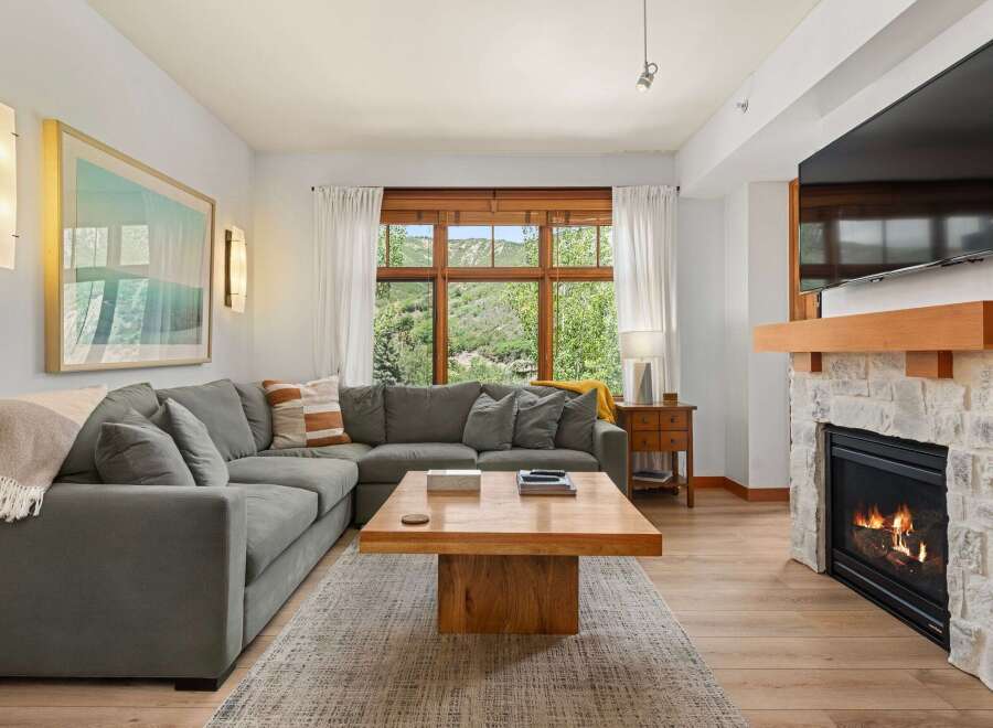 Experience ultimate comfort in this spacious living room, featuring a large sectional sofa perfect for gatherings.