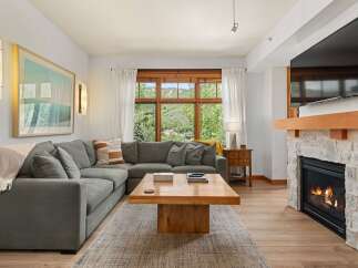 Experience ultimate comfort in this spacious living room, featuring a large sectional sofa perfect for gatherings.