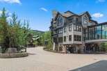 Discover luxury living in this stunning mountain resort property, featuring modern architecture with stone and wood accents.