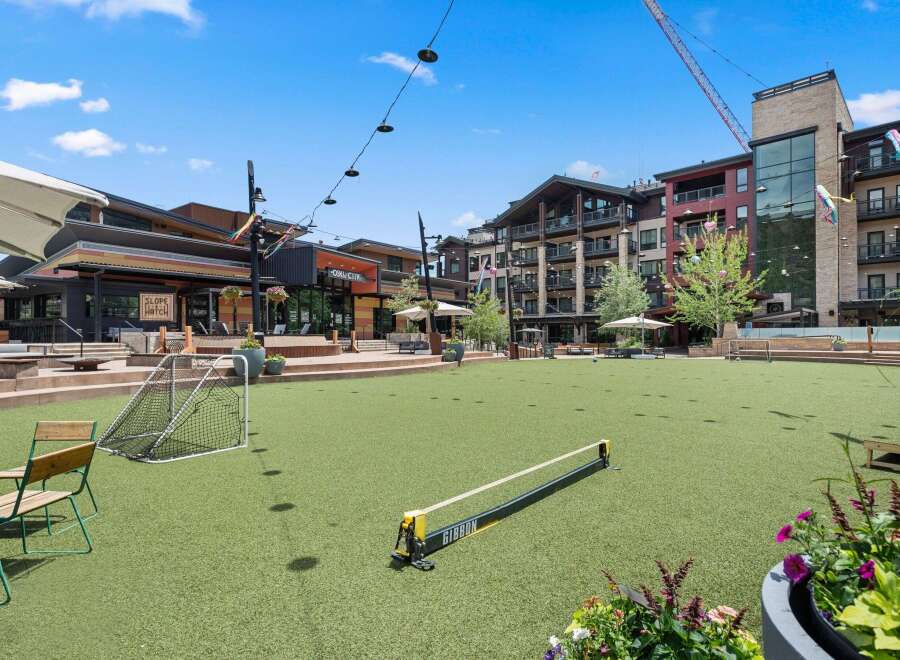 Experience outdoor living at its finest in this vibrant community space, featuring a lush green lawn perfect for recreation and relaxation.