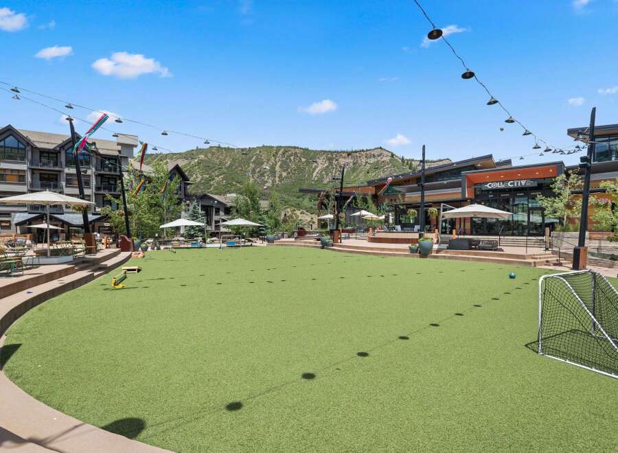 Experience outdoor living at its finest in this vibrant community space, featuring a lush artificial turf lawn perfect for recreation and relaxation.