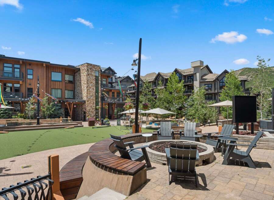 Experience outdoor living at its finest with this inviting courtyard featuring a central fire pit and ample seating.