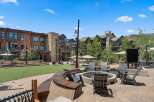 Experience outdoor living at its finest with this inviting courtyard featuring a central fire pit and ample seating.