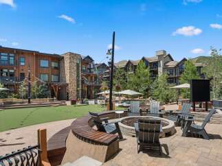 Experience outdoor living at its finest with this inviting courtyard featuring a central fire pit and ample seating.