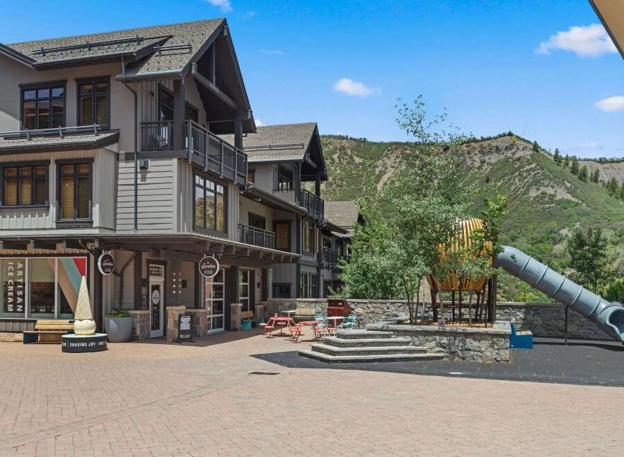Discover this charming commercial space featuring an artisan ice cream shop with a unique cone sculpture.