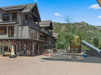 Discover this charming commercial space featuring an artisan ice cream shop with a unique cone sculpture.