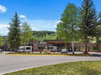 Discover this inviting hotel nestled amidst lush greenery and rolling hills, offering a serene mountain getaway.