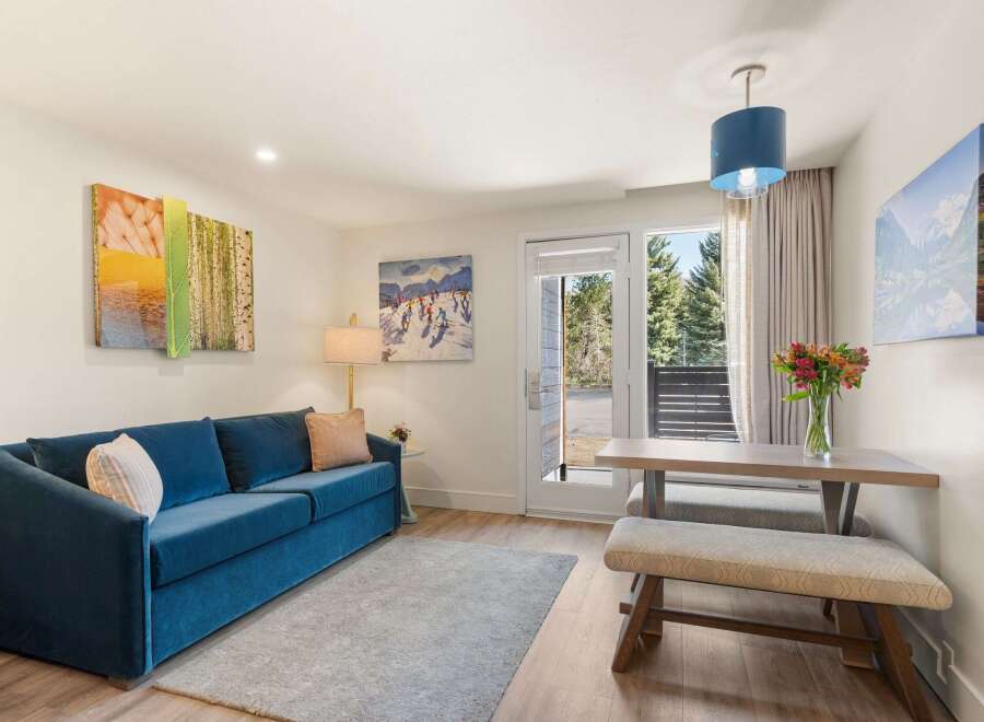 Experience comfort and style in this inviting living space, featuring a plush blue sofa perfect for relaxation.