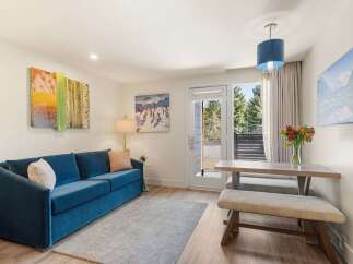 Experience comfort and style in this inviting living space, featuring a plush blue sofa perfect for relaxation.
