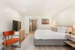 Experience comfort and style in this beautifully appointed hotel room, featuring a plush king-sized bed with crisp white linens and accent pillows.