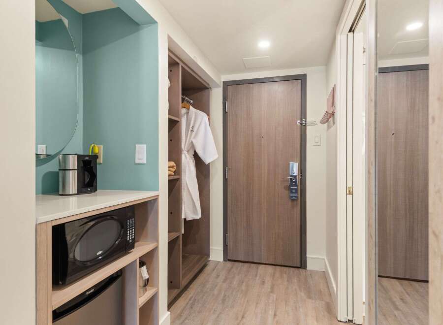 This hotel room offers convenient amenities, including a microwave, coffee maker, and a mini-fridge, perfect for a comfortable stay.