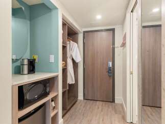 This hotel room offers convenient amenities, including a microwave, coffee maker, and a mini-fridge, perfect for a comfortable stay.