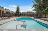 Experience luxury living with this stunning property featuring a pristine swimming pool and ample lounge seating, perfect for relaxation and entertainment.