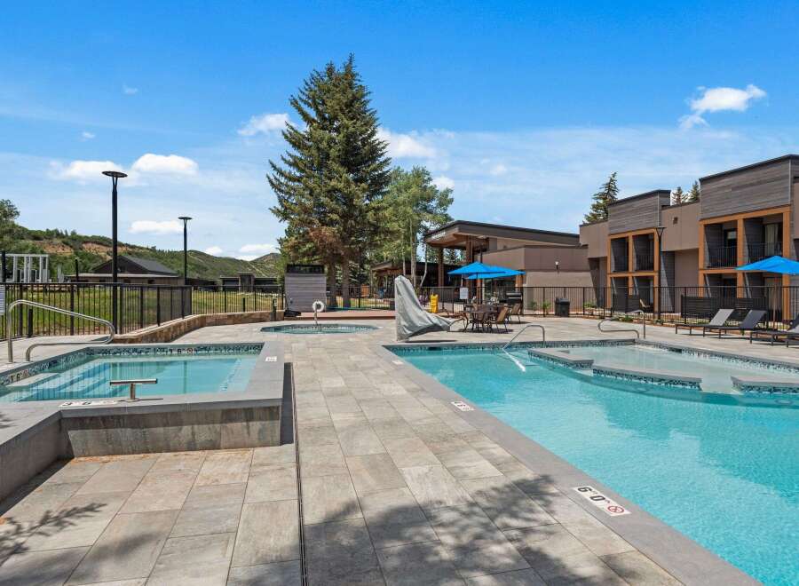 Experience luxury outdoor living with this stunning pool and spa area, perfect for relaxation and entertainment.
