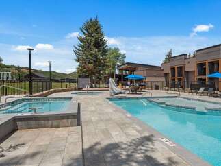 Experience luxury outdoor living with this stunning pool and spa area, perfect for relaxation and entertainment.