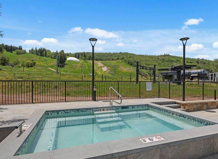 Enjoy a relaxing dip in this luxurious hot tub with stunning mountain views.