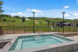 Enjoy a relaxing dip in this luxurious hot tub with stunning mountain views.