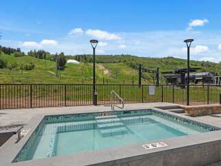 Enjoy a relaxing dip in this luxurious hot tub with stunning mountain views.