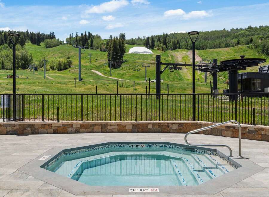 Enjoy a relaxing soak in this octagonal hot tub, complete with a stainless steel handrail for easy access.