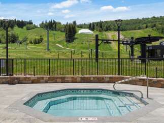 Enjoy a relaxing soak in this octagonal hot tub, complete with a stainless steel handrail for easy access.