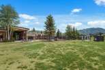 Experience the ultimate mountain getaway at this stunning property, featuring a modern lodge with ample seating and a cozy fire pit perfect for evening relaxation.