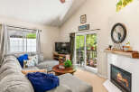 Cozy living room featuring a plush sectional sofa adorned with decorative pillows, a rustic wooden coffee table, and a modern entertainment center with a flat-screen TV.