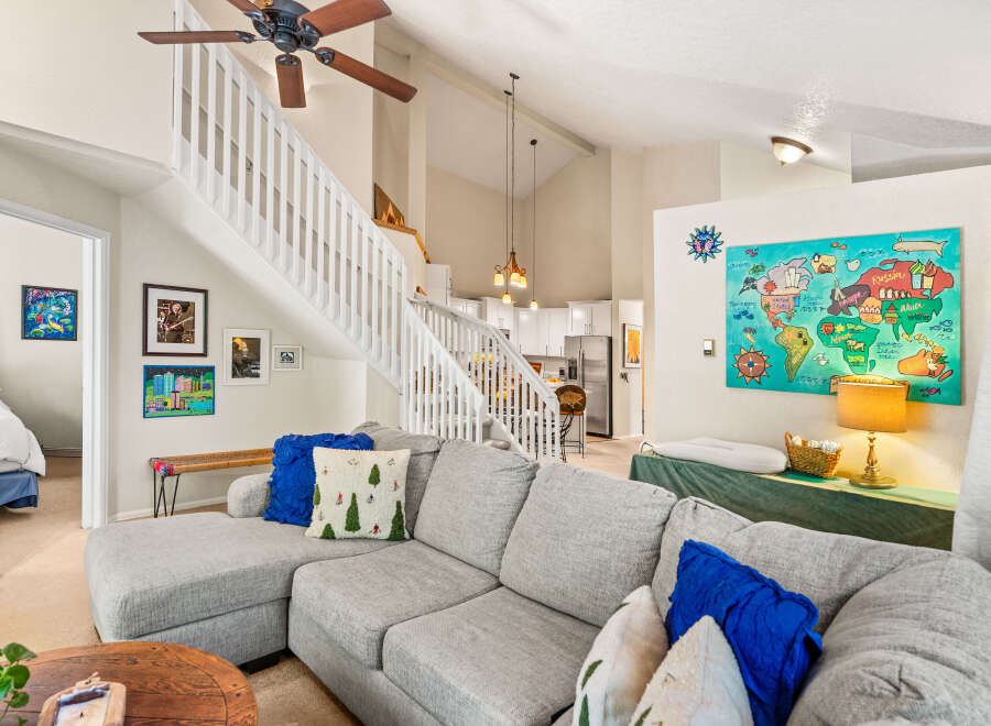 Experience the spaciousness of this open-concept living area, featuring a vaulted ceiling and a bright, airy atmosphere.