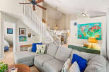Experience the spaciousness of this open-concept living area, featuring a vaulted ceiling and a bright, airy atmosphere.