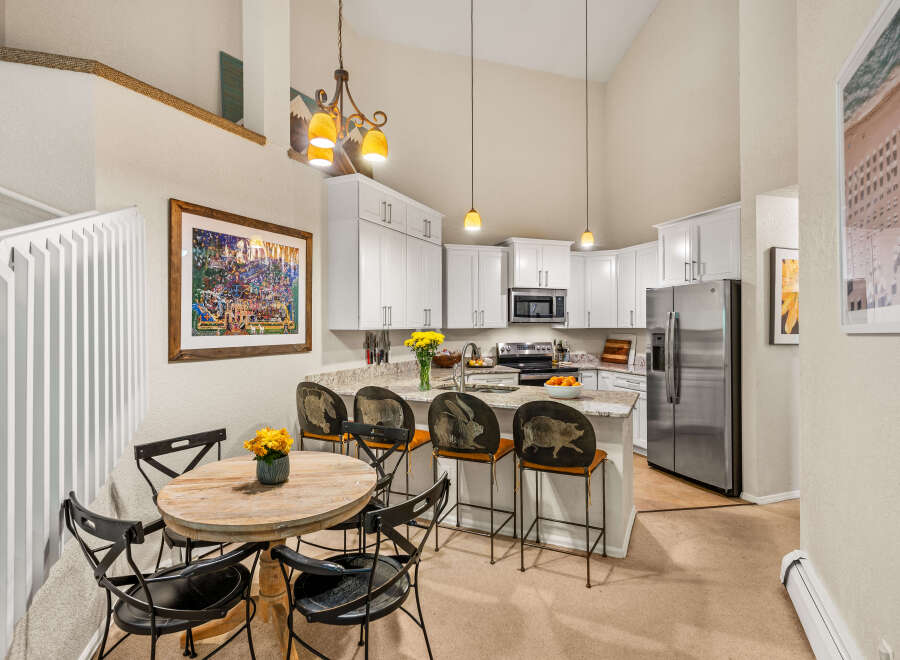 This spacious kitchen features white cabinetry, granite countertops, and a large island perfect for casual dining.