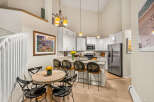 This spacious kitchen features white cabinetry, granite countertops, and a large island perfect for casual dining.