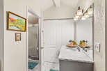 This bathroom features a spacious vanity with a marble countertop and dual sinks, perfect for busy mornings.