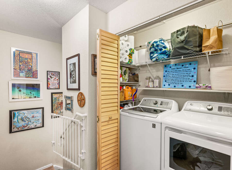 Discover a functional laundry space featuring a top-load washer and dryer, perfect for managing household chores.