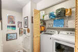 Discover a functional laundry space featuring a top-load washer and dryer, perfect for managing household chores.