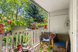 Enjoy your morning coffee on this charming balcony, surrounded by lush greenery and vibrant flowers.