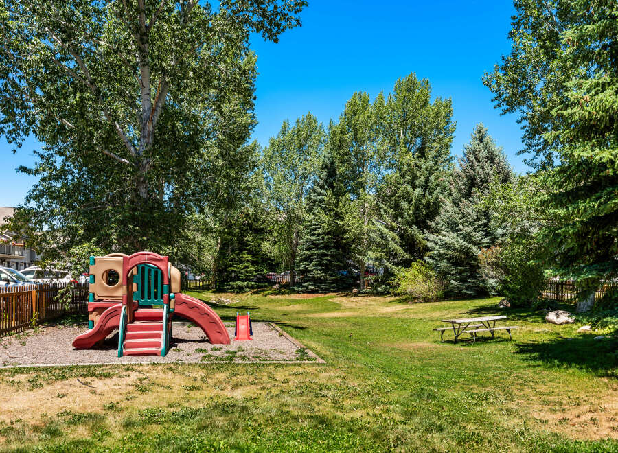 Enjoy outdoor fun in this property's dedicated playground area, complete with a colorful slide and climbing structure.