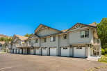 Discover modern living in this stunning townhome complex, featuring a row of attached garages with white doors and individual unit numbers.