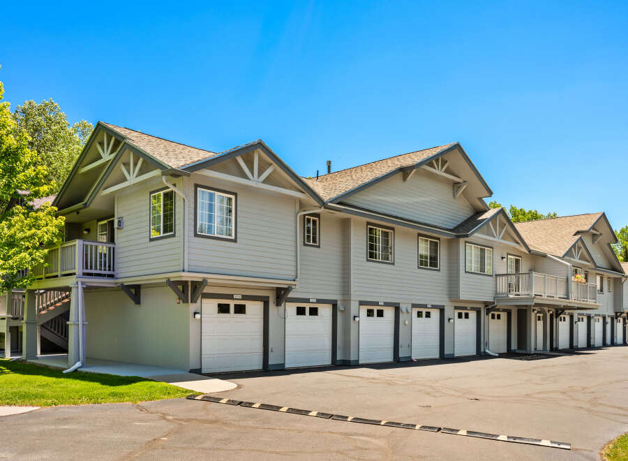 Discover modern living in this beautifully maintained townhome complex, featuring attached garages for convenient parking and storage.