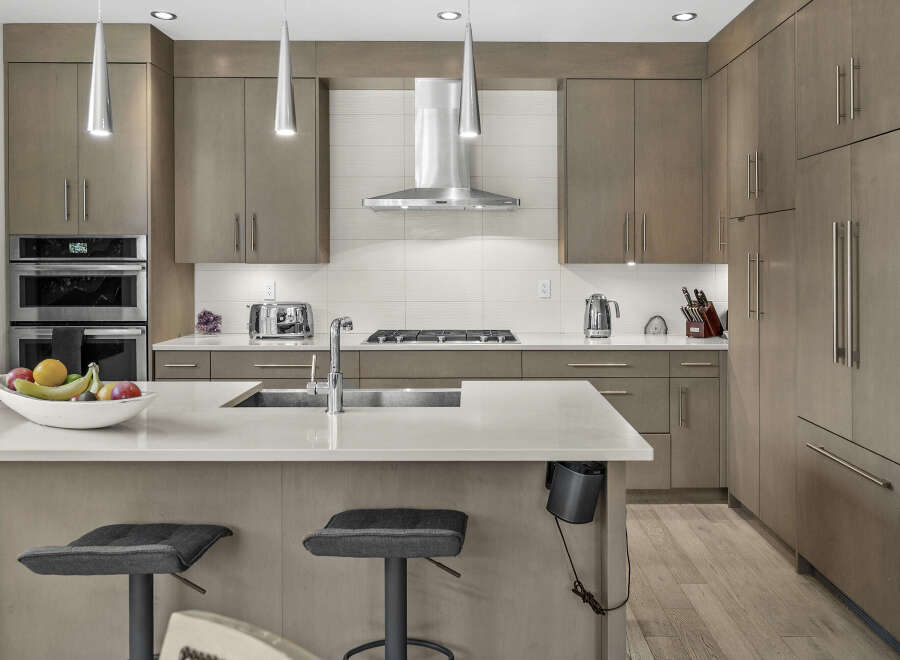 Experience modern luxury in this stunning kitchen, featuring sleek, custom cabinetry and high-end stainless steel appliances.